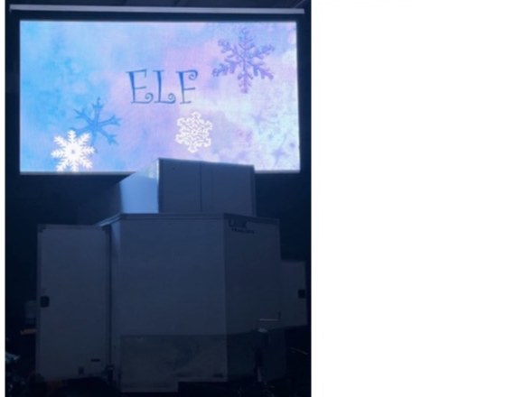 Outdoor LED video screen displaying movie content at night event
